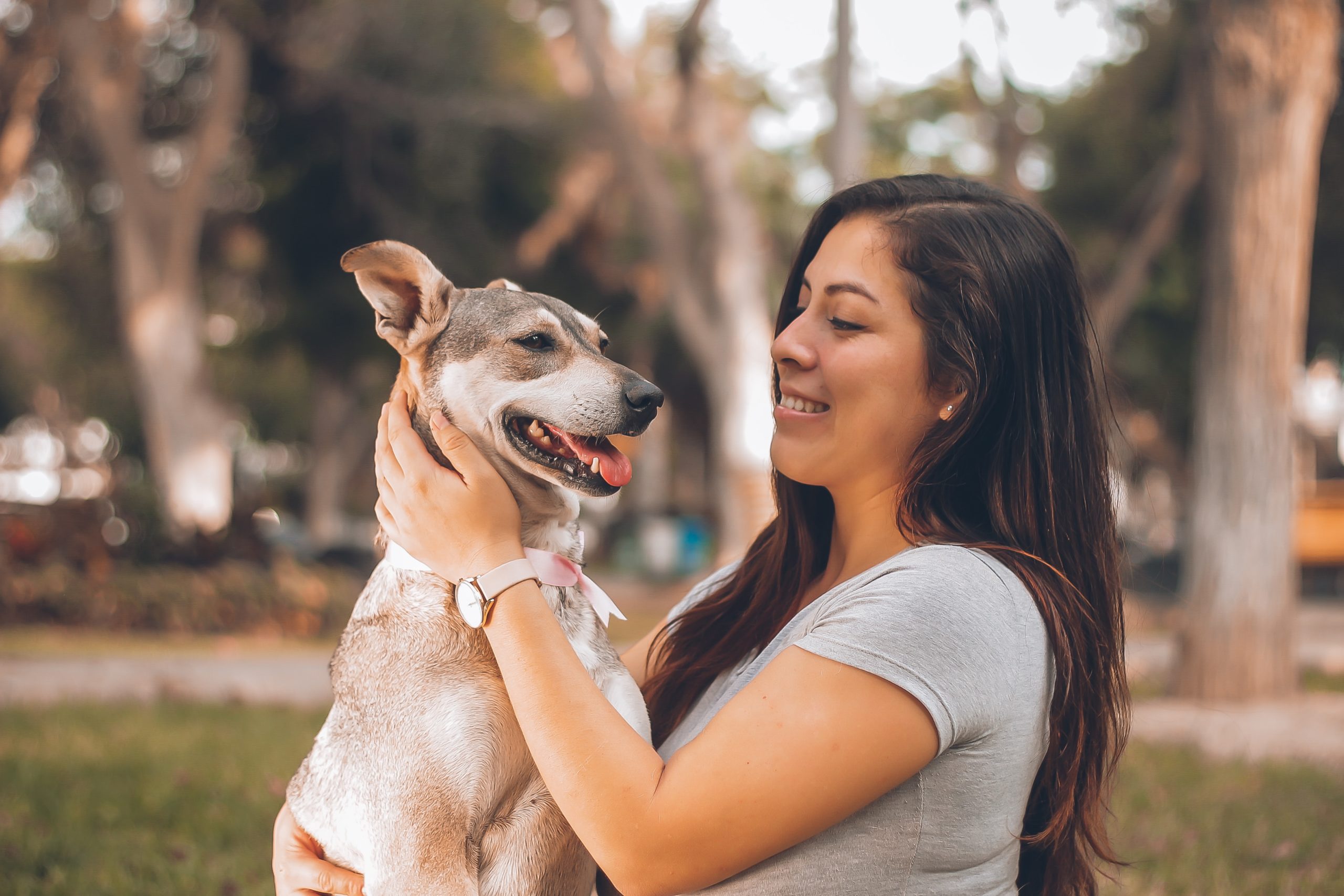 woman holding small dog