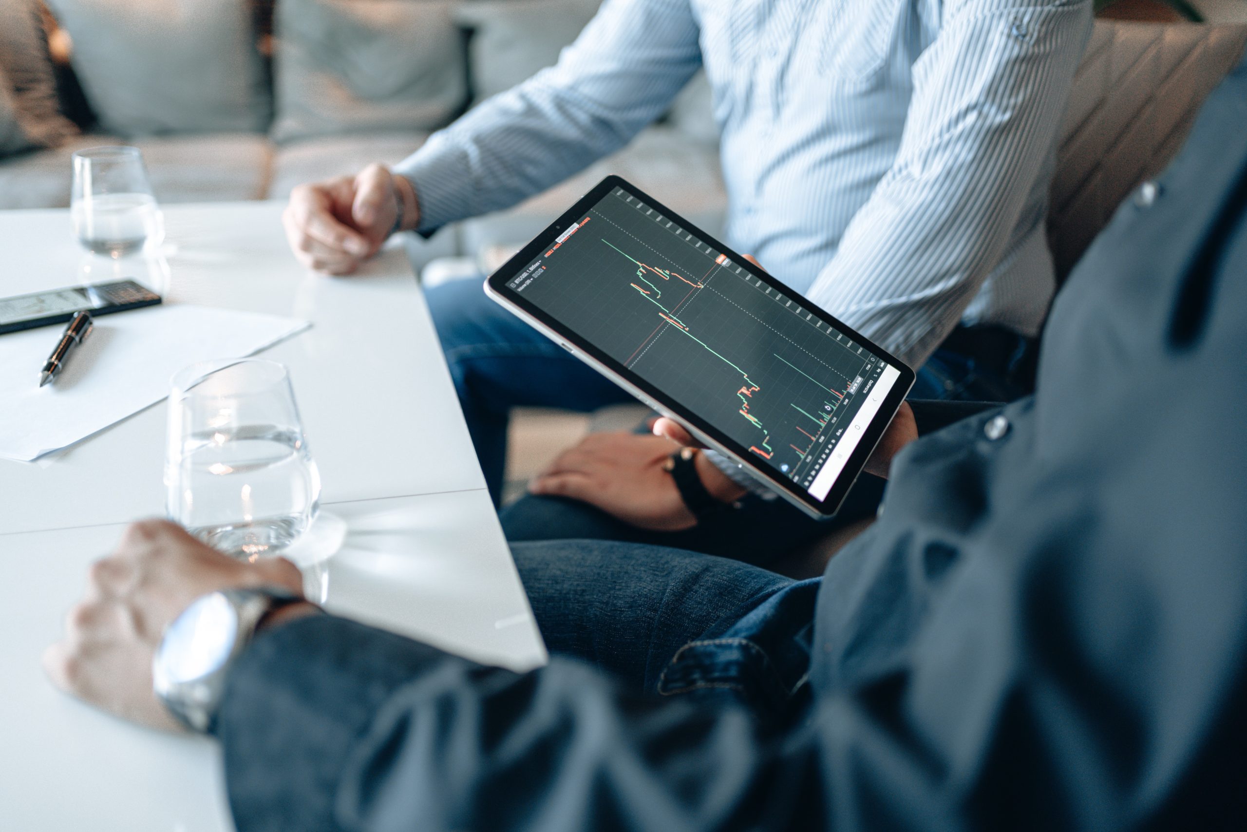 people looking at data on a tablet